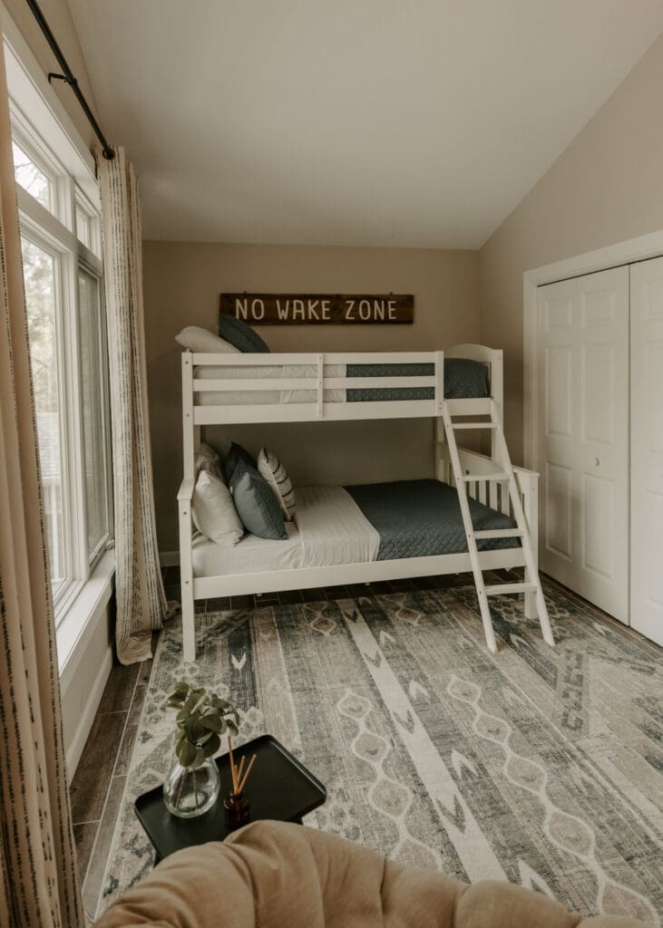 Family-friendly sleeping space with bunk beds and a queen bed at Camp Digs