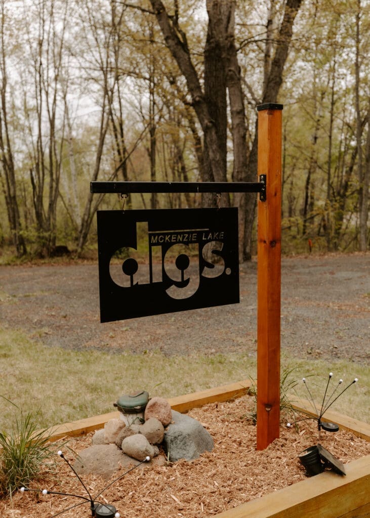 Family-friendly cabin getaway Wisconsin at Camp Digs sign in the Northwoods