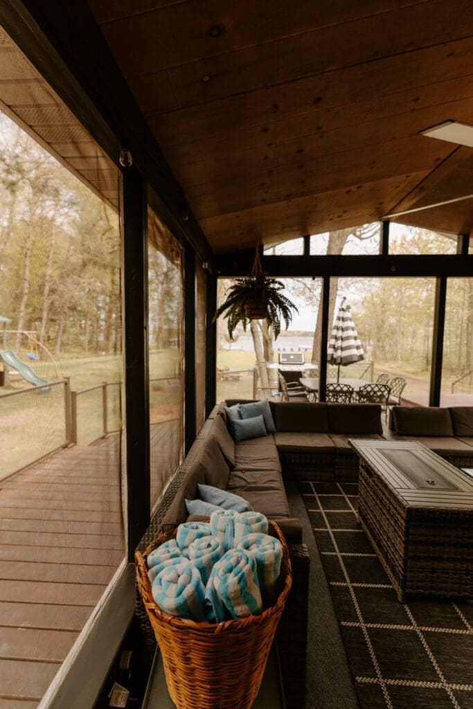 Four-season porch at Camp Digs offering comfortable seating and scenic Northwoods views year-round